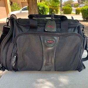 Tumi duffel bag. One of the side opens and it extends.
